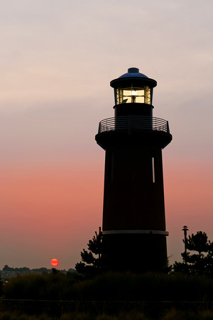 Lighthouse and a Red Sun